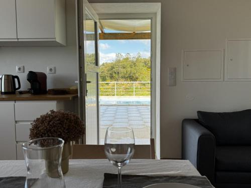 a wine glass sitting on a table in a kitchen at Refúgio sobre a paisagem alentejana in Mora