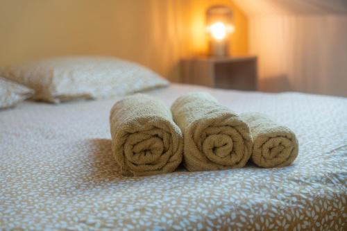 a pile of towels sitting on top of a bed at Iluka in Ault