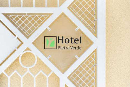 a picture of a hotel sign on a wall at Hotel Pietra Verde in Otranto
