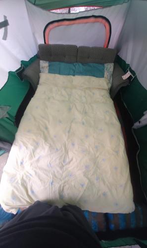 a bed in a tent with a white blanket at Phoenix Nights Guest House in Barrow in Furness