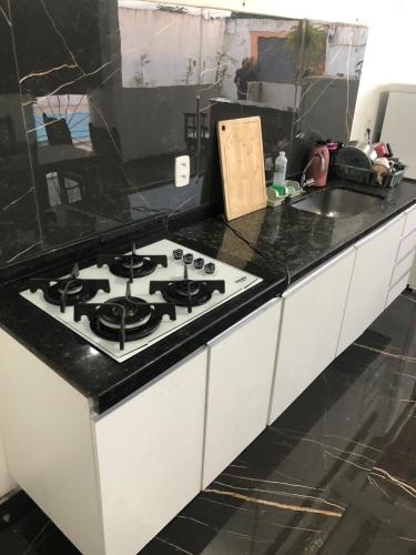 a kitchen with a stove and a counter top at Casa com piscina em Iranduba in Iranduba