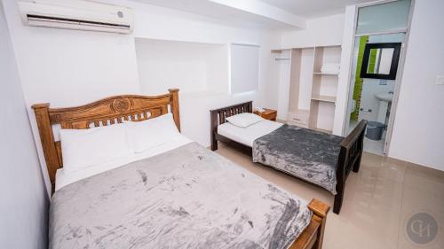 a bedroom with two beds in a room at Hotel Chayrama in Santa Marta