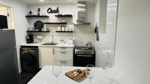 a kitchen with a counter with wine glasses on it at Casa da Marina in Angra do Heroísmo