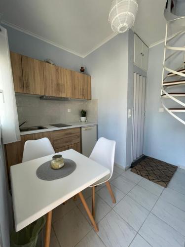 a kitchen with a white table and white chairs at The Little Prince in Petra