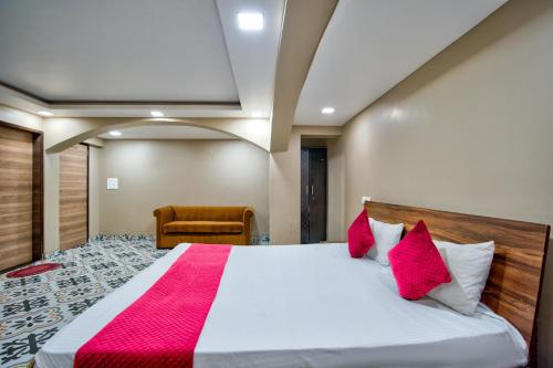 a bedroom with a large bed with red pillows at Luxury Aveeno Resort Near Calangute and Baga in Sangolda