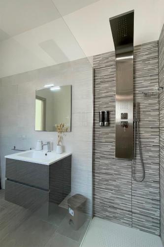 a bathroom with a sink and a shower at Rest House The Village in Nardò