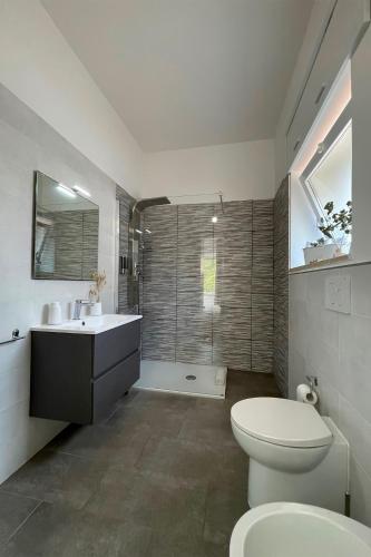 a bathroom with a toilet and a sink and a shower at Rest House The Village in Nardò