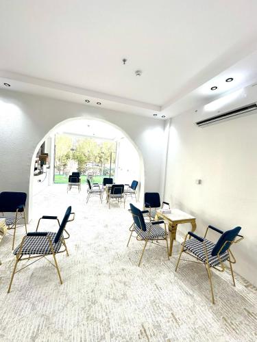 a room with chairs and tables and a large window at Golden Quba 1 in Riyadh