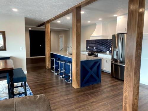 a kitchen with blue counter tops and a kitchen with a refrigerator at Bay Street Blue Ludington Park in Escanaba