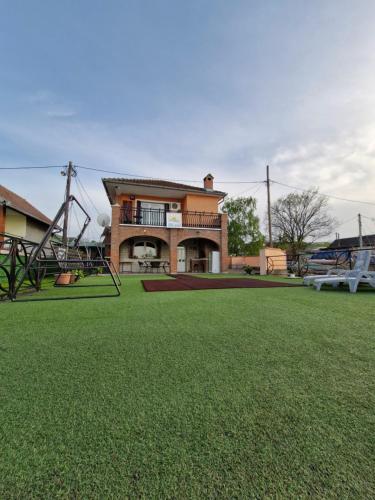 a house with a playground in front of a yard at Vila Soleil in Smederevo