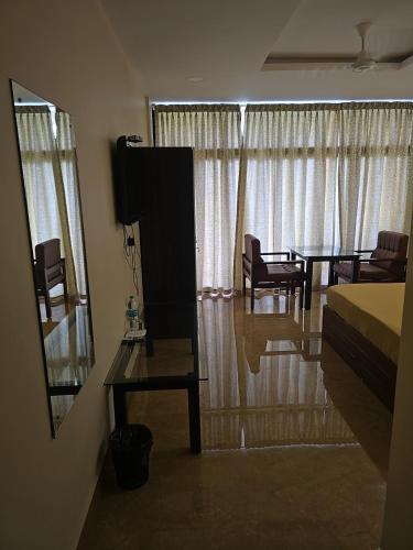 a bedroom with a bed and a table and chairs at BEAUTY SPOT MUNNAR in Munnar