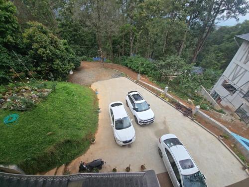 a group of cars parked in a parking lot at BEAUTY SPOT MUNNAR in Munnar