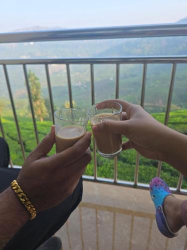 two people holding up glasses of beer at BEAUTY SPOT MUNNAR in Munnar
