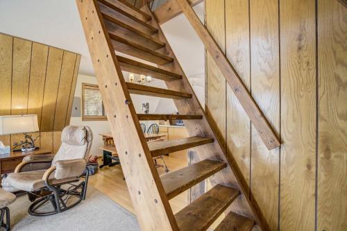 a staircase in a room with a desk and a chair at Slope Summit Rustic A-Frame Cabin w Scenic Views in Divide