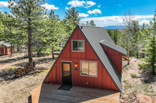 a red house with a gambrel roof at Slope Summit Rustic A-Frame Cabin w Scenic Views in Divide