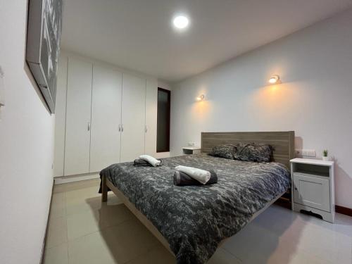 a bedroom with a bed with two pillows on it at Urban, Quiet flat for Digital & Remote Nomads in Santa Cruz de Tenerife