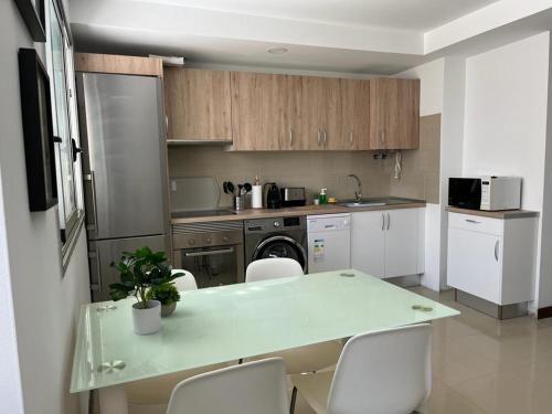 a kitchen with a table and chairs in a kitchen at Urban, Quiet flat for Digital & Remote Nomads in Santa Cruz de Tenerife