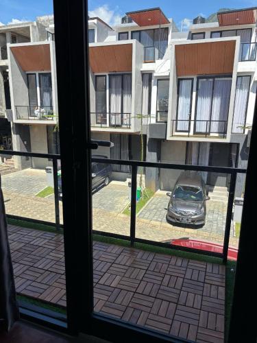 a view from a window of a parking lot with a car at Villa Srikandi Caldera D5 in Tlekung