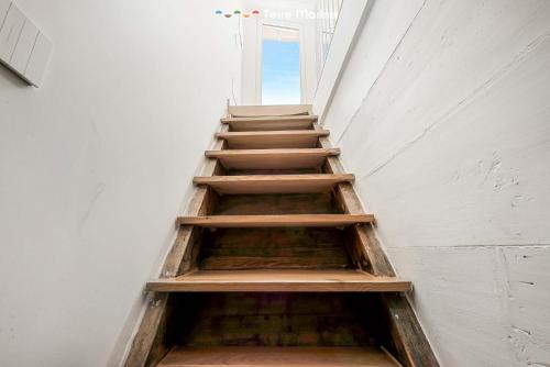 a stair case in a building with wooden steps at Le Dimore dei Fiori, Terre Marine in La Spezia