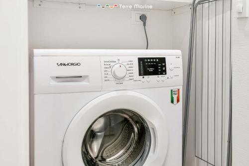 a white washer and dryer in a room at Le Dimore dei Fiori, Terre Marine in La Spezia