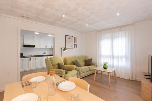 a living room with a table and a couch at El Retiro de Julián in Santa Pola