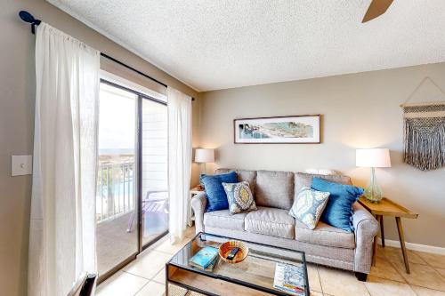 a living room with a couch and a glass table at Plantation East 2205 in Gulf Shores