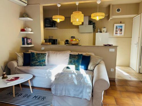 un salon avec un canapé et une table dans l'établissement Charmant et cosy T2 à deux pas du port dans un quartier calme, à Cavalaire-sur-Mer