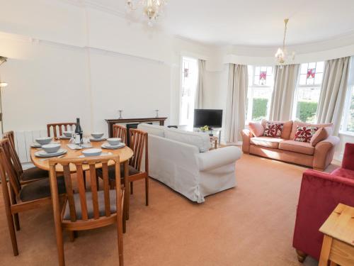a living room with a table and a couch at Seawinds in Colwyn Bay