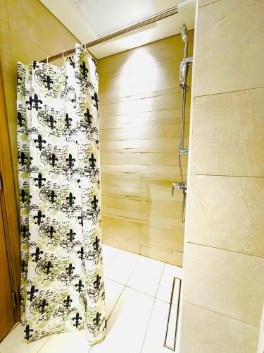 a shower in a bathroom with a shower curtain at La Vista Holiday Home in Dubai