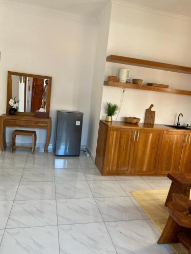 a living room with a television and a mirror at Villa Katak Singaraja in Babakan Sangsit