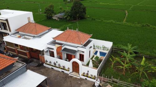 an aerial view of a white house with red roofs at Villa Katak Singaraja in Babakan Sangsit