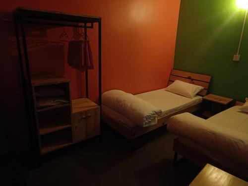 a small bedroom with two beds and a mirror at Hotel Baishnav, Mugling Kurintar Mankamana in Upardāng Garhi