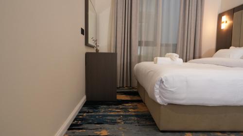 a hotel room with two beds and a window at The bright View hotel in Al Khafji