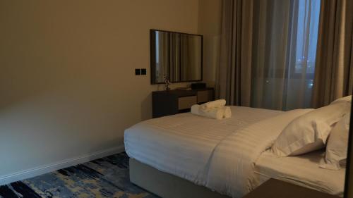 a bedroom with a bed with two towels on it at The bright View hotel in Al Khafji
