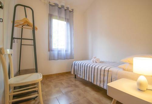 a room with a bed and a ladder and a window at Centro San Teodoro in San Teodoro
