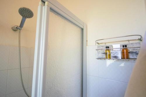 a shower with a glass door in a bathroom at Centro San Teodoro in San Teodoro