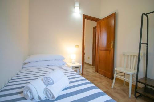 a bedroom with a bed with towels on it at Centro San Teodoro in San Teodoro