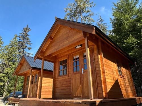 a wooden cabin with a gambrel roof at Garden Bay Hideaway - Glamping & RV in Garden Bay