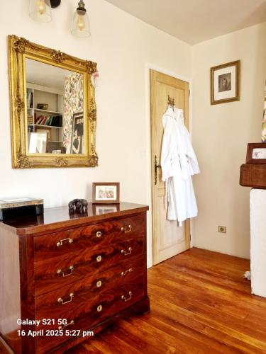 a bedroom with a dresser and a mirror at Maison Maisy in Navarrenx