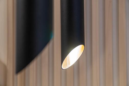 a light hanging from the side of a wall at Tiny magic studio in Corfu