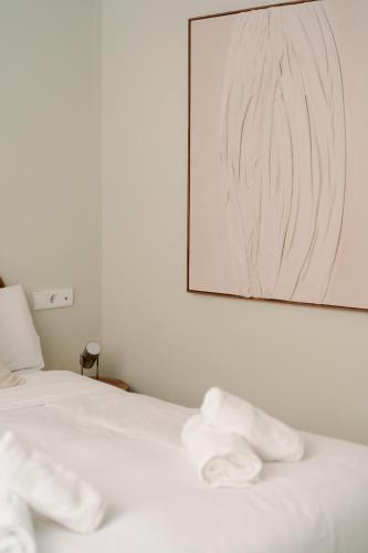 a bedroom with a bed with white towels on it at Cream Boutique Málaga in Málaga