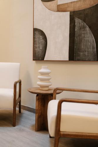 a living room with a table and a chair at Cream Boutique Málaga in Málaga
