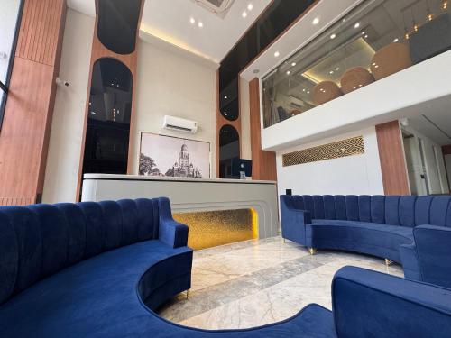 a store with two blue couches in a room at Hotel Mumbai House Vijay Nagar Nr Brilliant Convention Center in Indore
