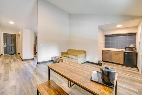 a living room with a table and a kitchen at 1 Mi to Riverfront Sleek Port Huron Studio in Port Huron