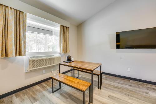 a room with a table and a tv and a window at 1 Mi to Riverfront Sleek Port Huron Studio in Port Huron