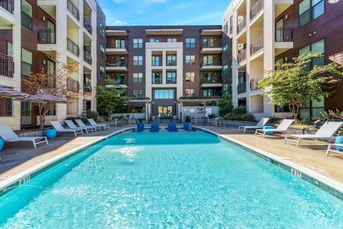 a swimming pool in the middle of a apartment complex at Mid-Century Charm in Midtown Nashville in Nashville