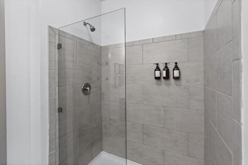 a bathroom with a shower with a glass door at Mid-Century Charm in Midtown Nashville in Nashville