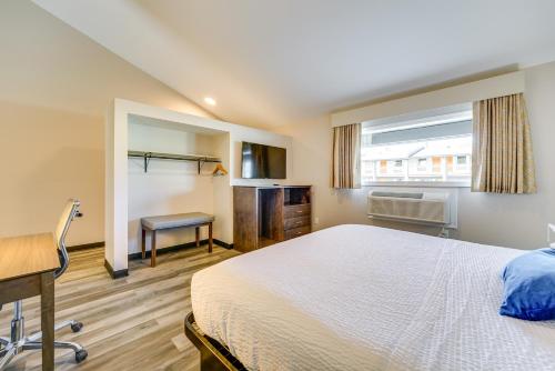 a bedroom with a bed and a desk and a window at WFH-Friendly Studio Near Lighthouse Beach! in Port Huron