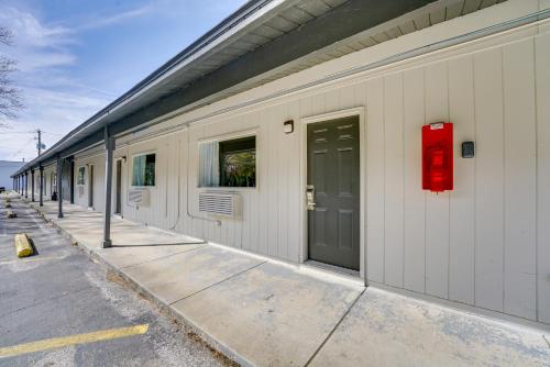 a building with a red door on the side of it at WFH-Friendly Studio Near Lighthouse Beach! in Port Huron