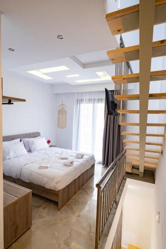a bedroom with a bed and a staircase at Sotiris Luxury Villas in Limenaria